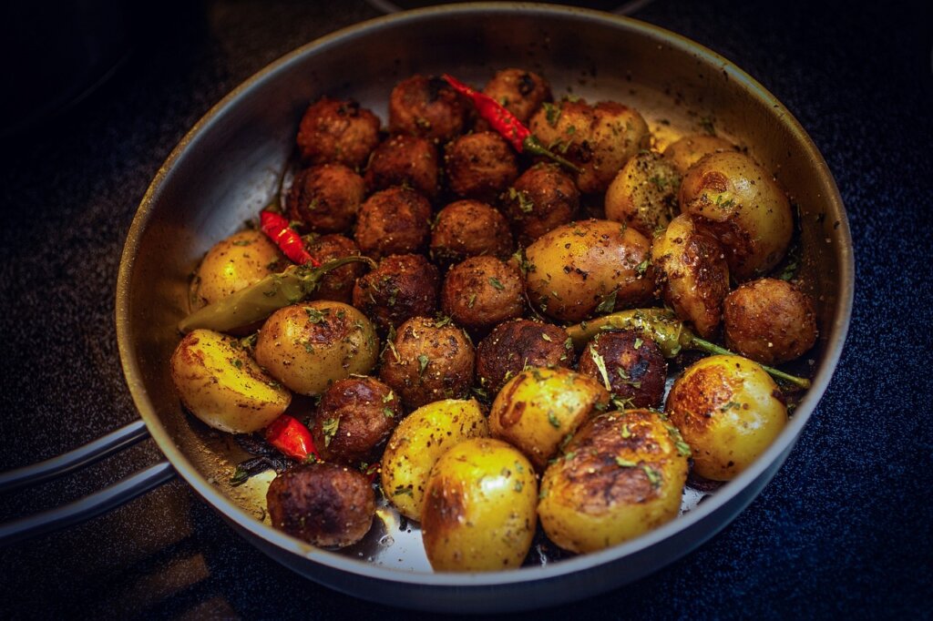 A pan full of meatballs and potatoes