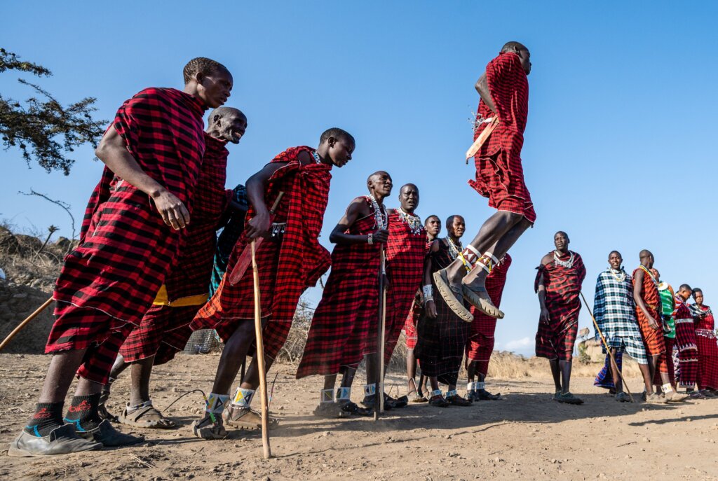 Maasai warrior jumping high into the air