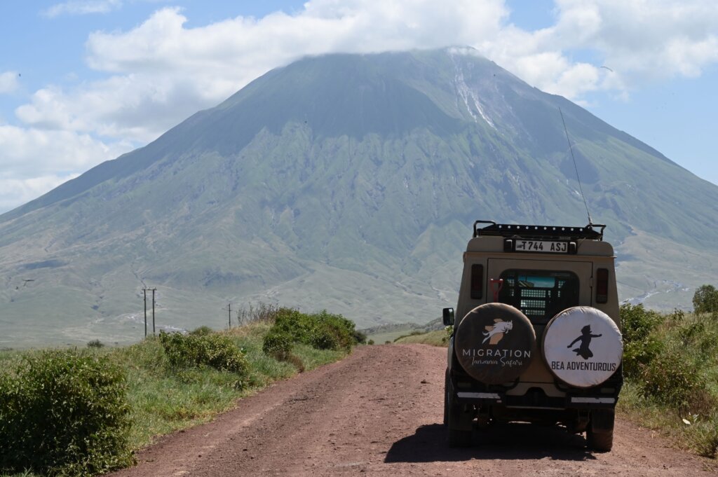 Safari truck parked at the foot of Ol Donyo Lengai