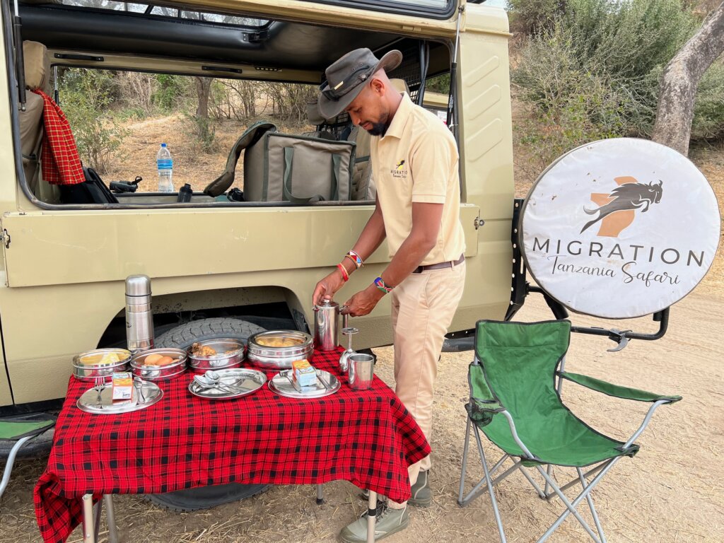 Malaki from Migration Tanzania Safari laying out lunch for us