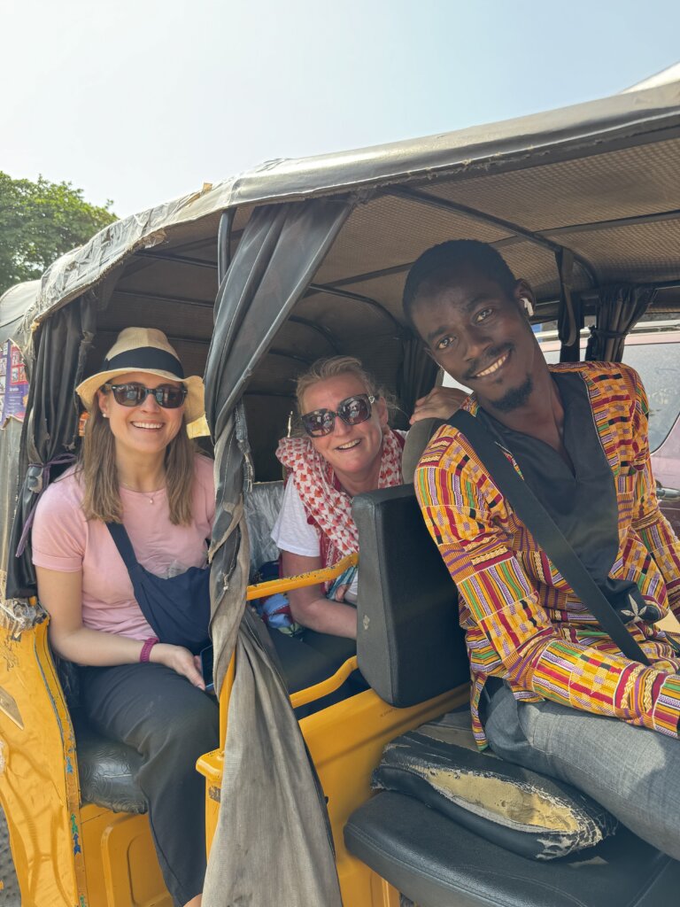 Sierra Leone Group Tour customers smiling in a tuk tuk