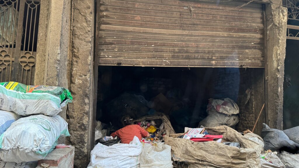 Woman shifting through rubbish in Garbage City - Cairo