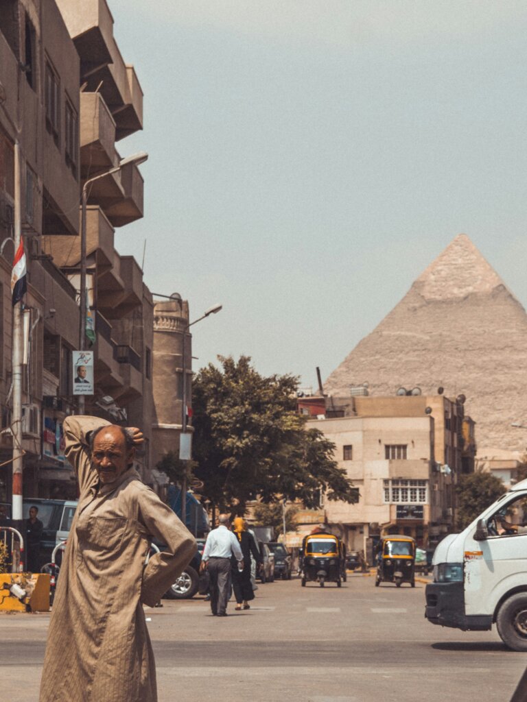 Street in Cairo with the Pyramids in the background