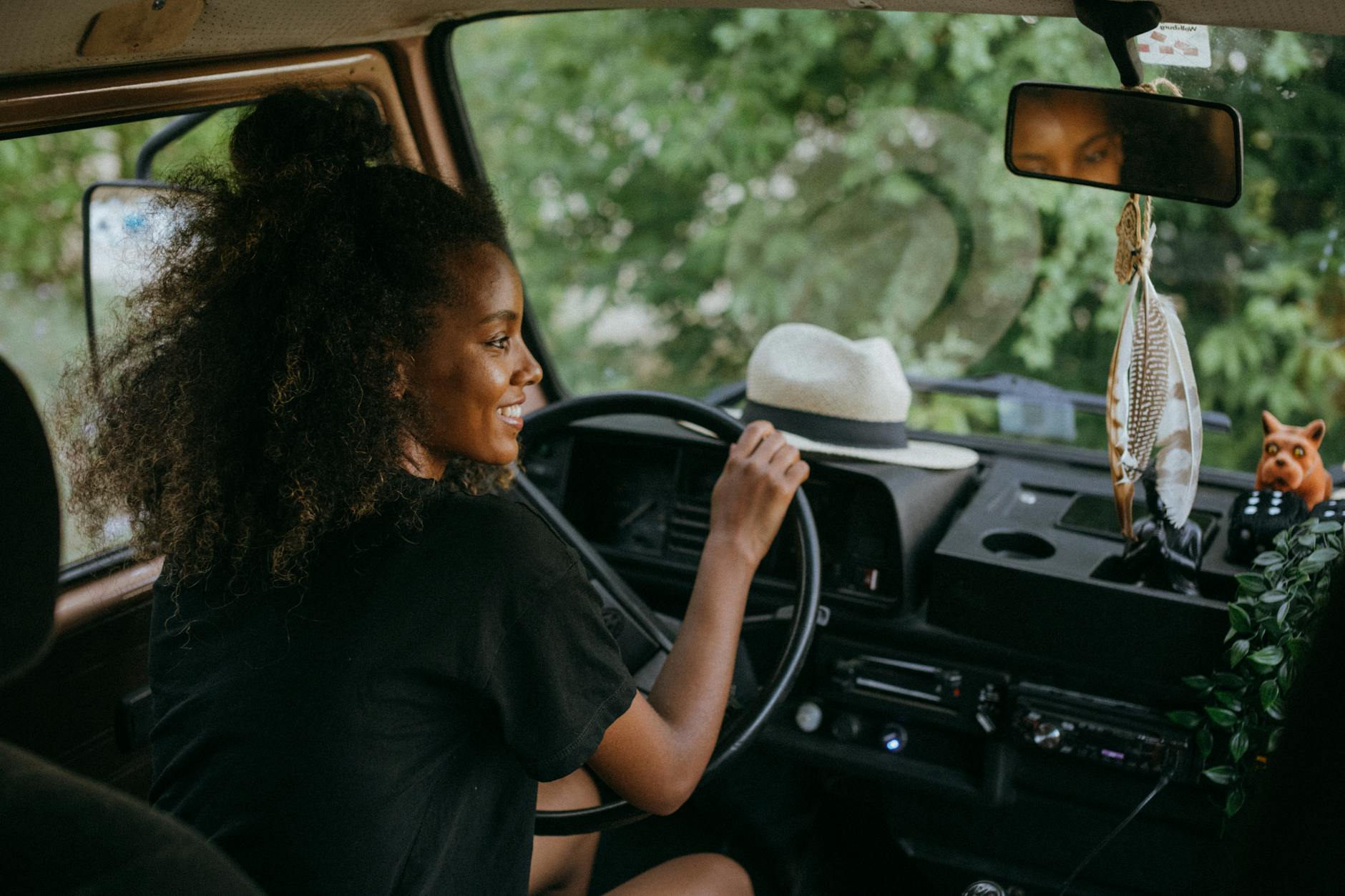 woman in black shirt driving car