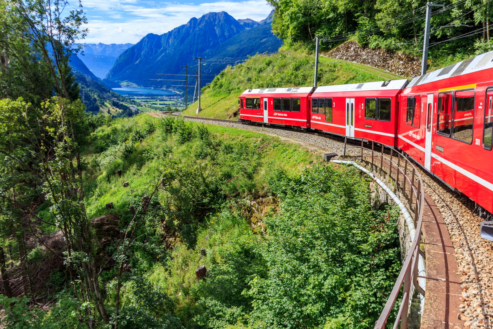 red train in mountains in switzerland